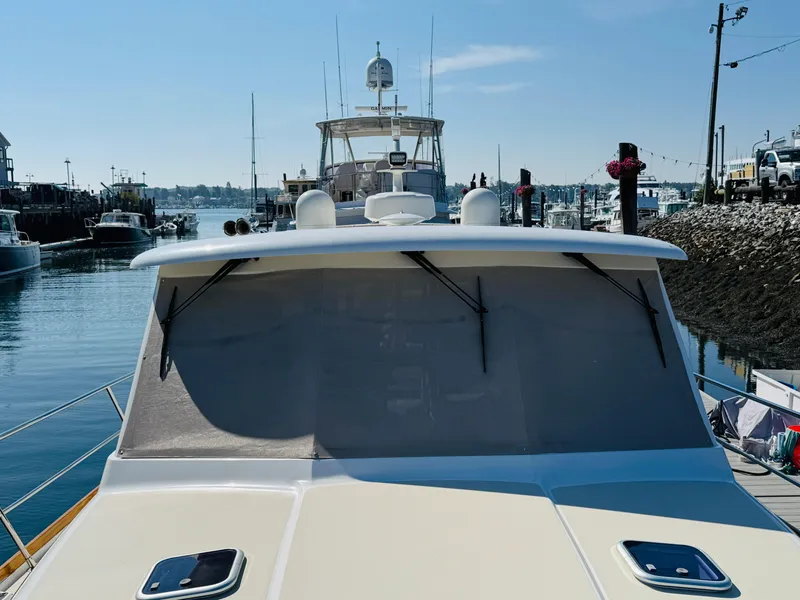 Slide: The Image of 2018 Sabre 42 Salon Express yacht docked in a marina under clear skies. - 42