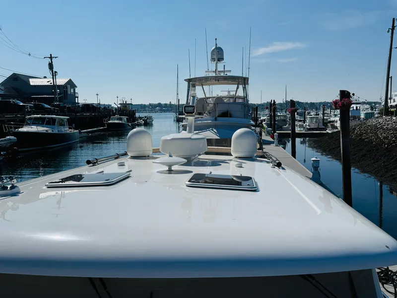 Slide: The Image of 2018 Sabre 42 Salon Express yacht docked at a marina under clear blue skies. - 43