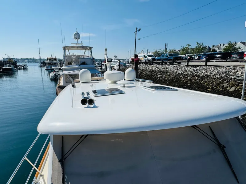Slide: The Image of 2018 Sabre 42 Salon Express yacht docked at a marina under clear blue skies. - 44