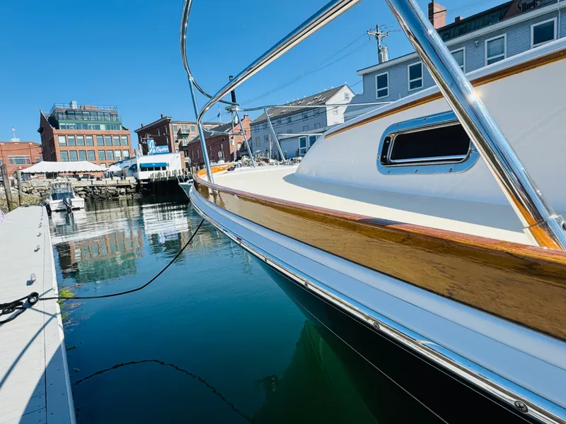 Slide: The Image of 2018 Sabre 42 Salon Express yacht docked in a marina, reflecting on calm water. - 48