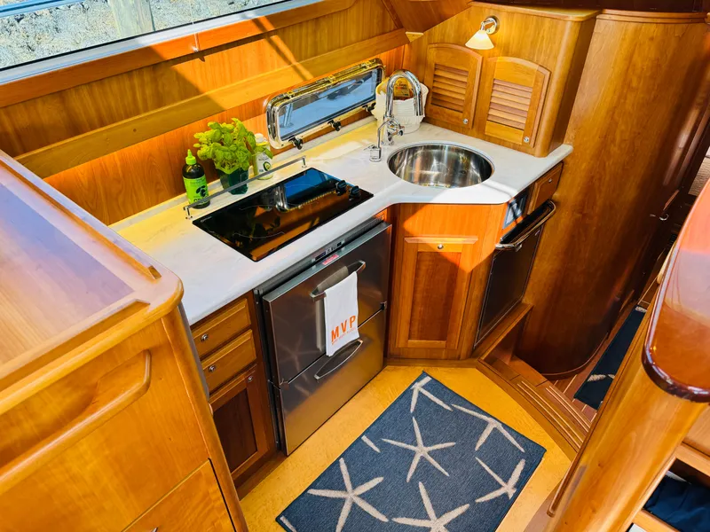 Slide: The Image of Luxurious galley in 2018 Sabre 42 Salon Express yacht with wood cabinetry and modern appliances. - 9