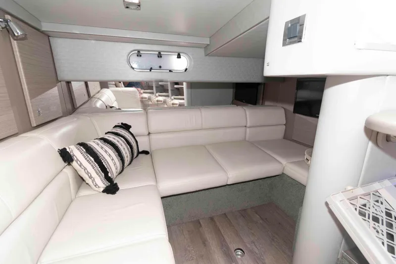 Slide: The Image of 2018 Formula 34 PC yacht interior with white leather seating and decorative pillow. - 17