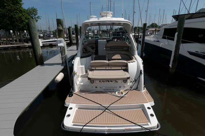 Slide: The Image of 2018 Formula 34 PC yacht docked at marina, featuring spacious seating and swim platform. - 2