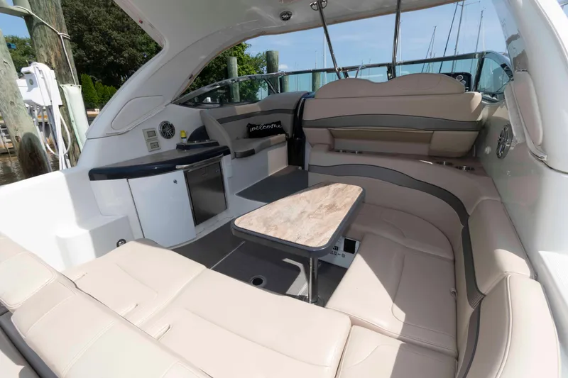 Slide: The Image of 2018 Formula 34 PC boat interior with beige seating and compact kitchenette. - 4