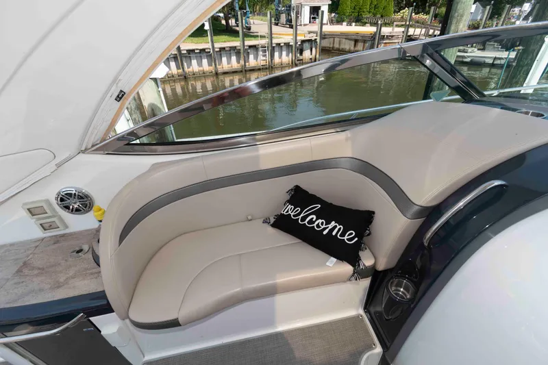 Slide: The Image of 2018 Formula 34 PC yacht interior with beige seating and "Welcome" pillow. - 9