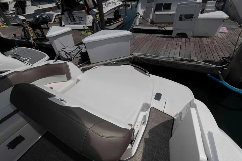 Slide: The Image of 2018 Monterey 295 Sport Yacht at dock, featuring spacious seating and sleek design. - 11