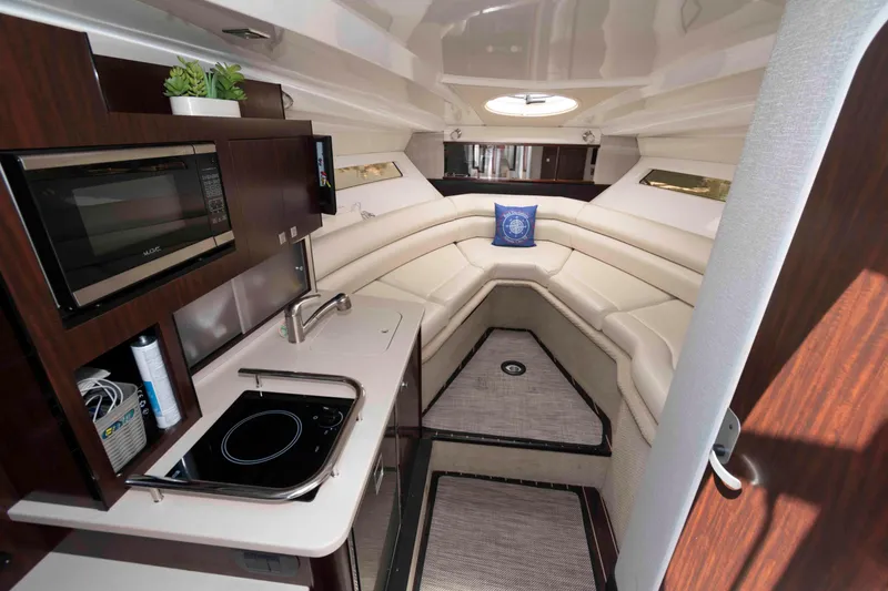Slide: The Image of Interior of 2018 Monterey 295 Sport Yacht with kitchenette and seating area. - 13