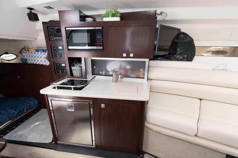 Slide: The Image of Interior of 2018 Monterey 295 Sport Yacht with kitchenette and seating area. - 15