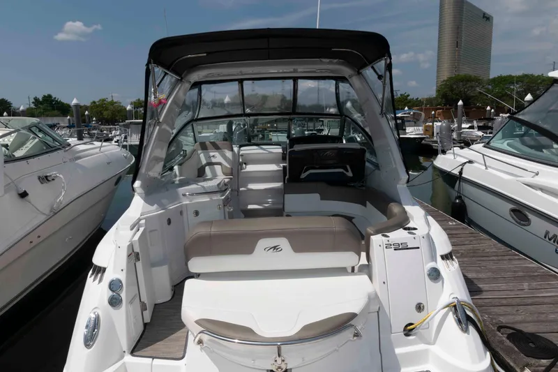 Slide: The Image of 2018 Monterey 295 Sport Yacht docked at marina, featuring spacious seating and sleek design. - 2