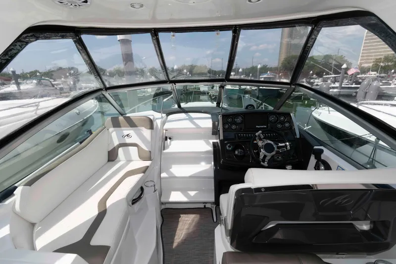 Slide: The Image of 2018 Monterey 295 Sport Yacht cockpit with modern controls and seating. - 5