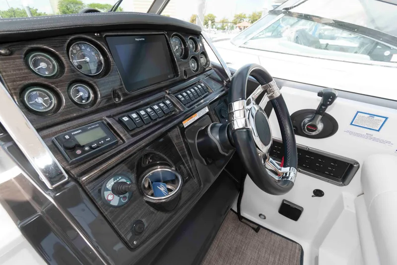 Slide: The Image of Cockpit of 2018 Monterey 295 Sport Yacht with modern controls and steering wheel. - 7