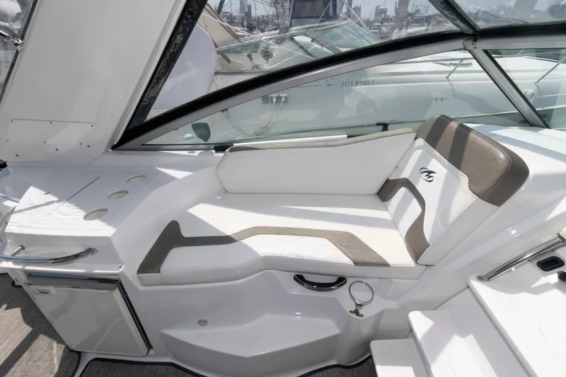 Slide: The Image of 2018 Monterey 295 Sport Yacht interior with white seating and sleek design. - 9