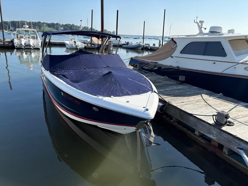 Slide: The Image of 2012 Cobalt A28 boat docked at marina, covered and ready for use. - 1