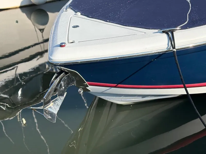 Slide: The Image of 2012 Cobalt A28 boat bow with anchor, docked on calm water. - 14