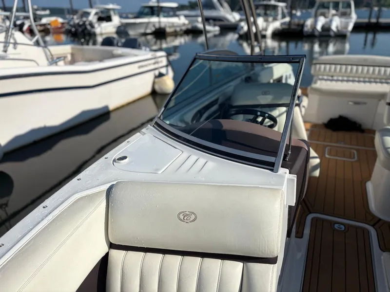 Slide: The Image of 2012 Cobalt A28 boat interior with white seating, docked at marina. - 21