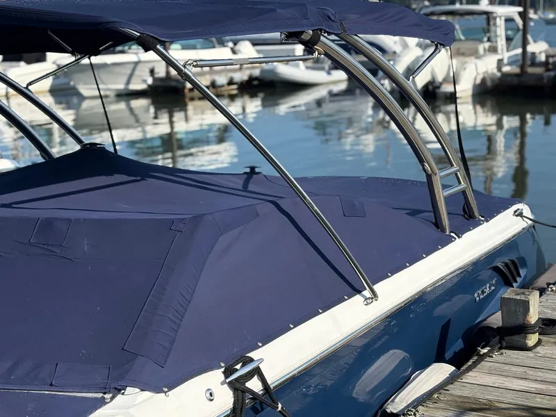 Slide: The Image of 2012 Cobalt A28 boat with blue cover docked at marina. - 8