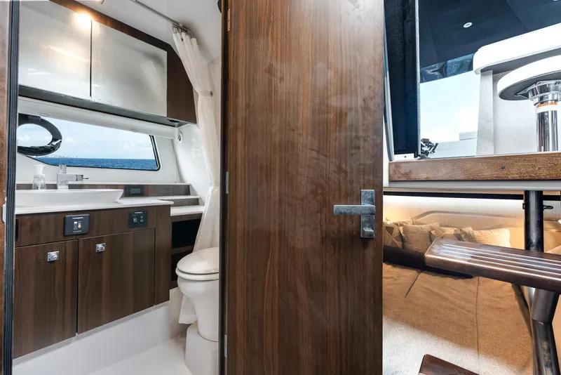 Slide: The Image of 2023 Cruisers Yachts 42 GLS OB interior with modern bathroom and cozy cabin. - 12