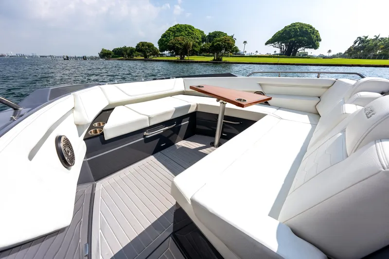 Slide: The Image of Luxurious seating area on 2023 Cruisers Yachts 42 GLS OB, overlooking serene waters. - 14