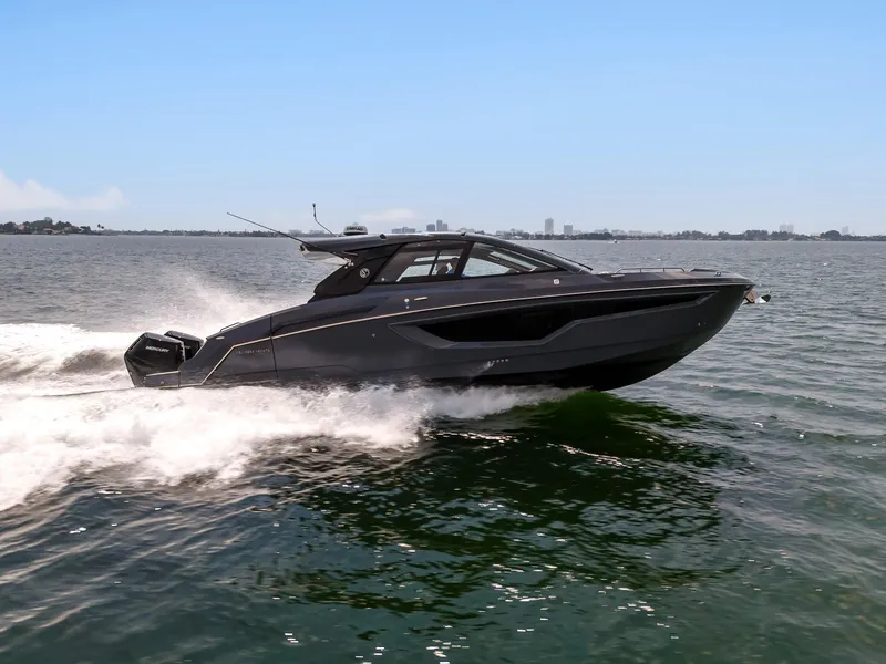 Slide: The Image of 2023 Cruisers Yachts 42 GLS OB speeding on open water, showcasing sleek design and performance. - 3