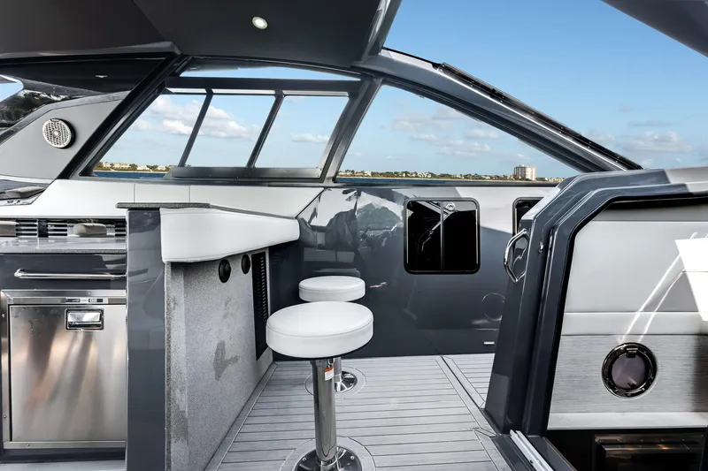 Slide: The Image of 2023 Cruisers Yachts 42 GLS OB interior with modern bar stools and sleek design. - 33