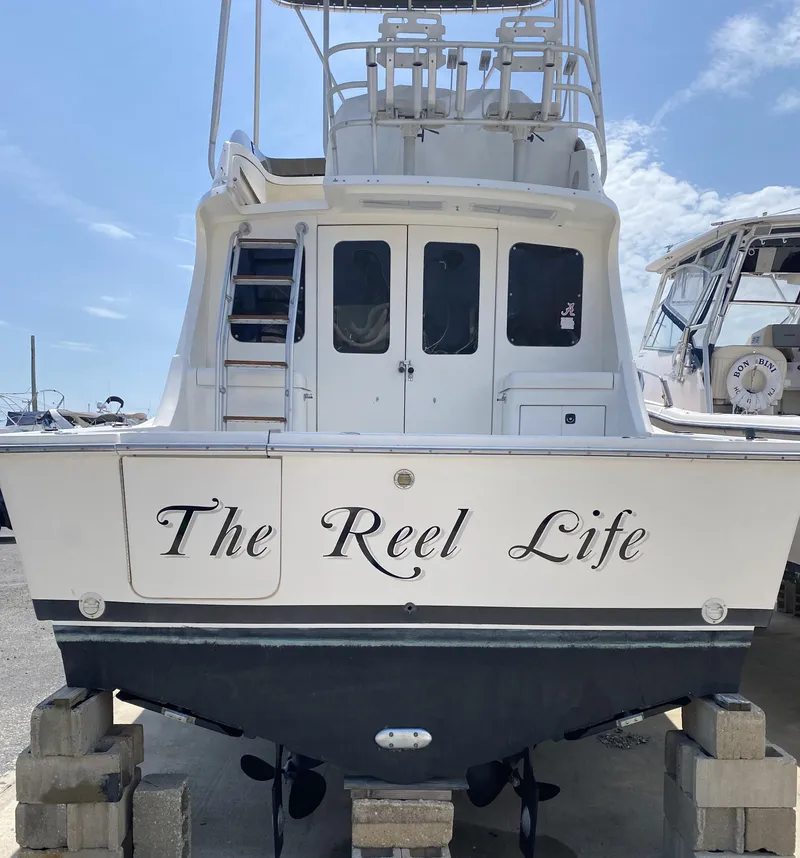 Slide: The Image of 1992 Luhrs Tournament 320 Convertible boat named "The Reel Life" on dry dock. - 13