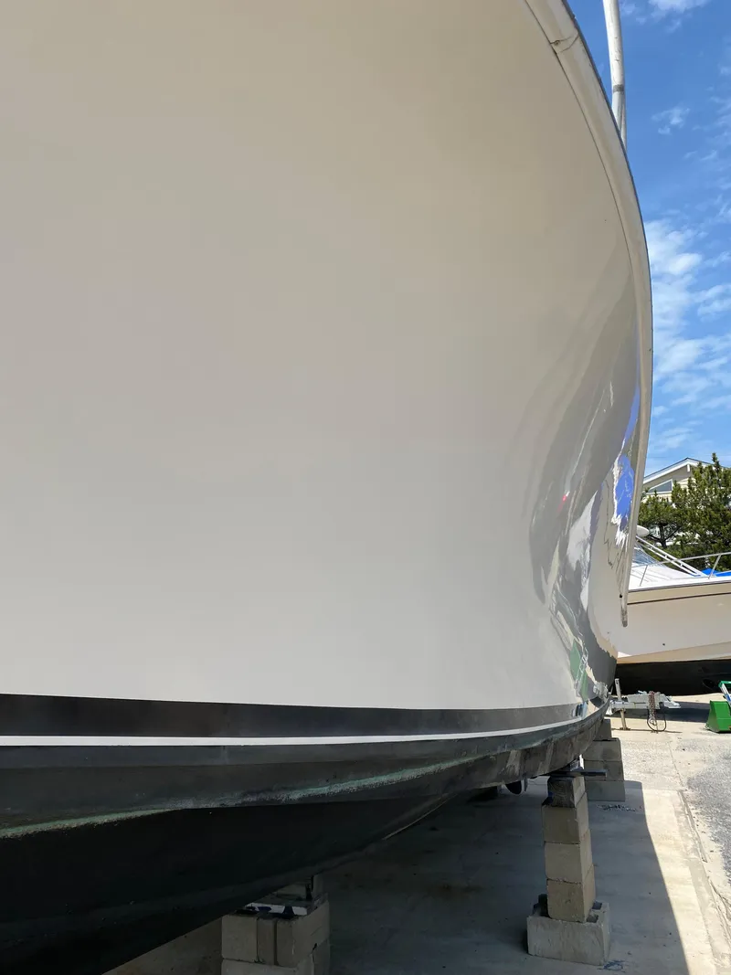 Slide: The Image of 1992 Luhrs Tournament 320 Convertible boat hull on blocks, side view. - 14