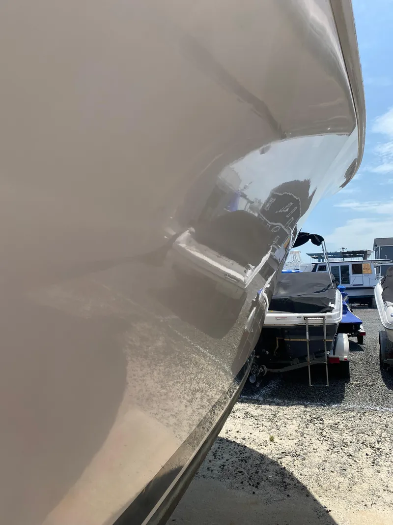 Slide: The Image of 1992 Luhrs Tournament 320 Convertible boat hull in a marina setting. - 15