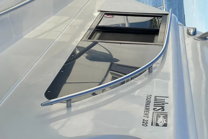 Slide: The Image of 1992 Luhrs Tournament 320 Convertible boat deck with window and railing. - 16