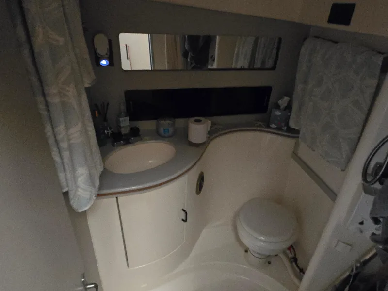 Slide: The Image of Bathroom interior of 1992 Luhrs Tournament 320 Convertible boat, featuring sink and toilet. - 5
