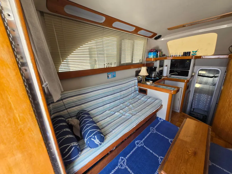 Slide: The Image of Interior of 1992 Luhrs Tournament 320 Convertible with striped seating and compact kitchen area. - 6