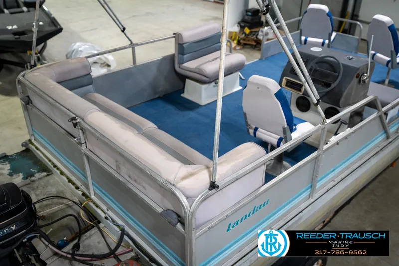 Slide: The Image of 1988 Landau 20 Adventurer boat interior with seating, displayed in a showroom. - 19