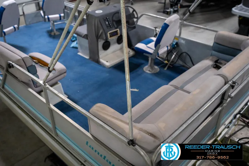 Slide: The Image of 1988 Landau 20 Adventurer boat interior with seating, displayed in a showroom. - 20