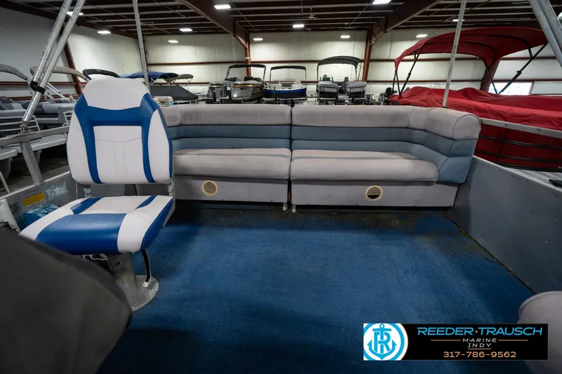 Slide: The Image of 1988 Landau 20 Adventurer boat interior with gray seating in a showroom. - 22
