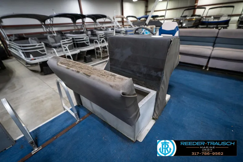 Slide: The Image of 1988 Landau 20 Adventurer pontoon boat with Mercury outboard motor in a showroom. - 35