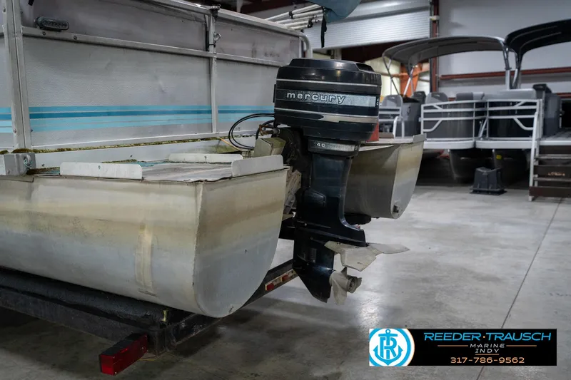 Slide: The Image of 1988 Landau 20 Adventurer boat with a 40 HP Mercury outboard motor in a showroom. - 37