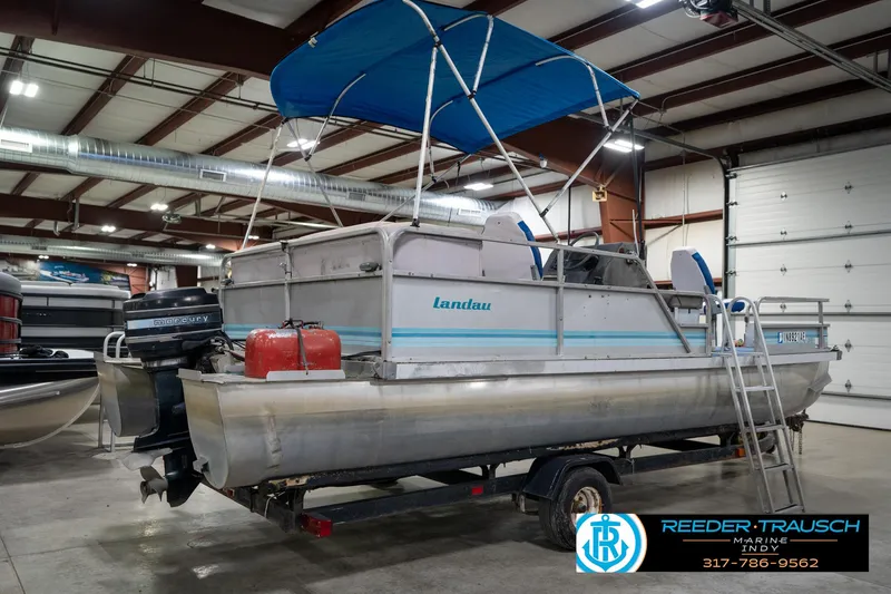 Slide: The Image of 1988 Landau 20 Adventurer pontoon boat with blue canopy in indoor storage. - 6