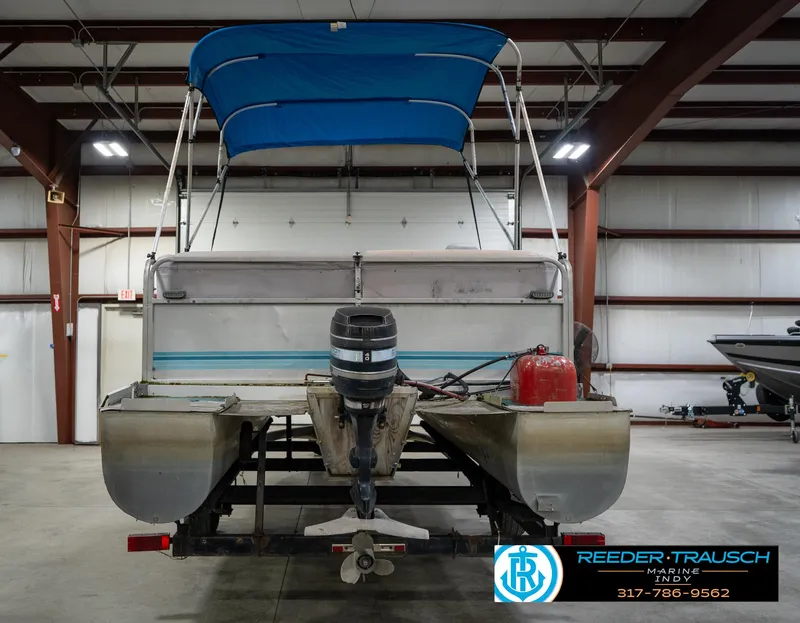 Slide: The Image of 1988 Landau 20 Adventurer pontoon boat with blue canopy in indoor storage. - 7