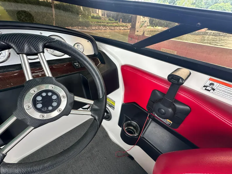 Slide: The Image of Interior of 2008 Regal 2200 RS boat with steering wheel and controls. - 8