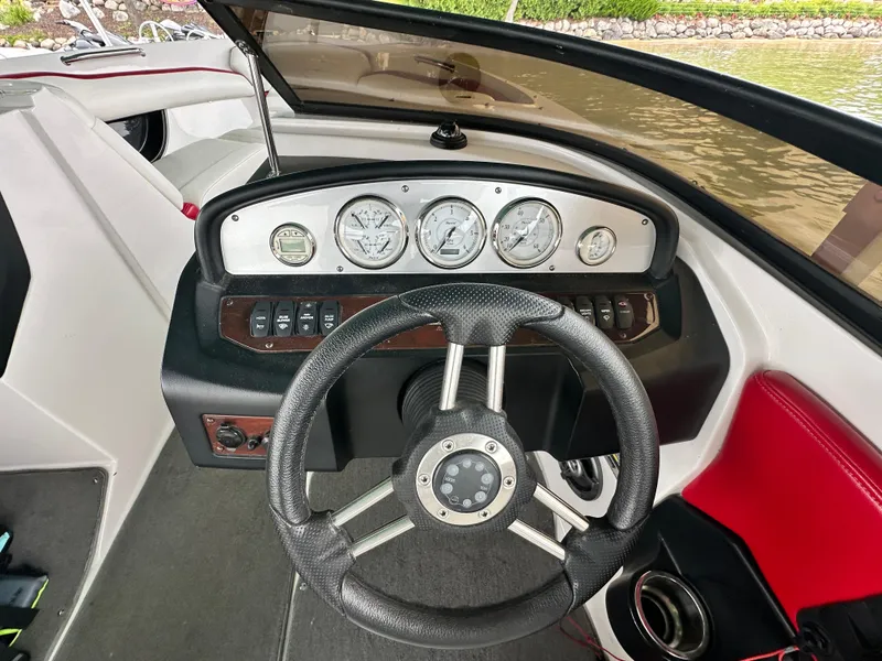 Slide: The Image of Steering wheel and dashboard of a 2008 Regal 2200 RS boat. - 9