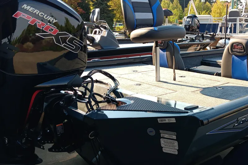 Slide: The Image of 2025 Ranger RT188P boat with Mercury Pro XS engine, featuring blue seating and spacious deck. - 4