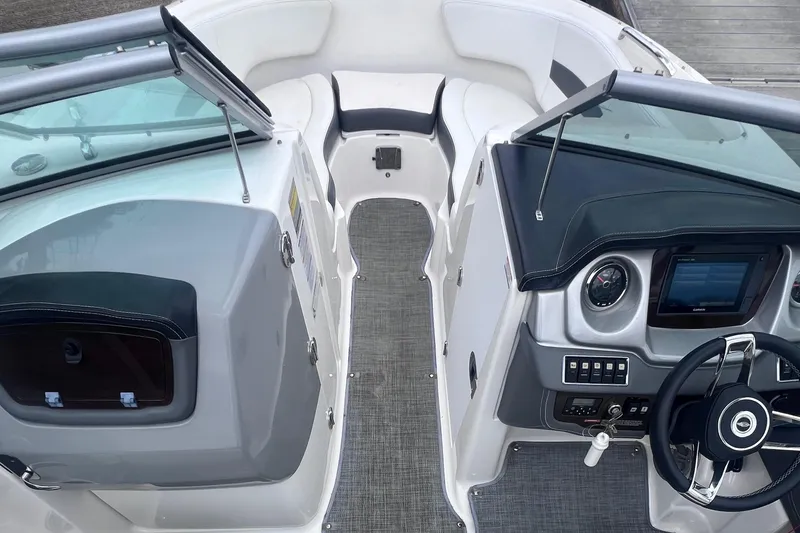 Slide: The Image of Dashboard controls of a 2015 Chaparral 224 Sunesta boat, featuring various switches and a gauge. - 11