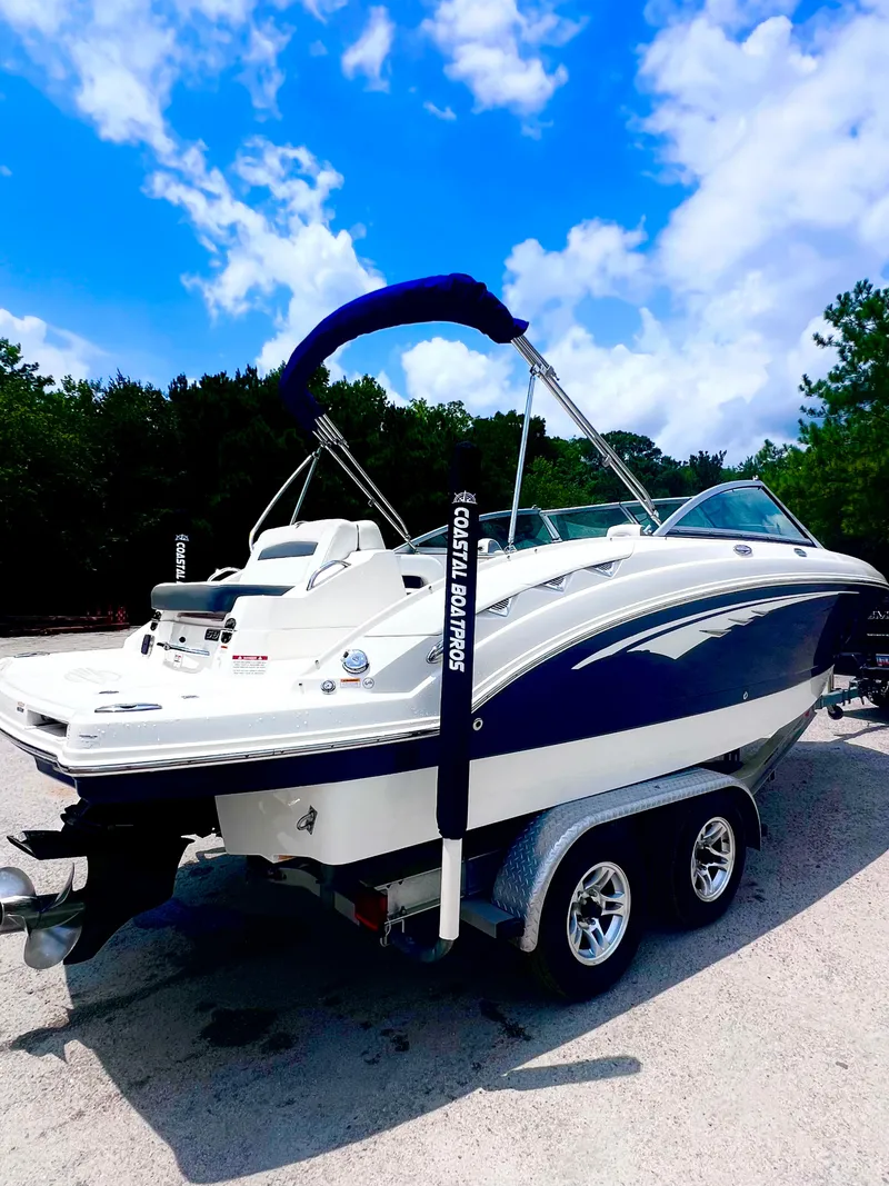 Slide: The Image of 2015 Chaparral 224 Sunesta boat on trailer under blue sky. - 3