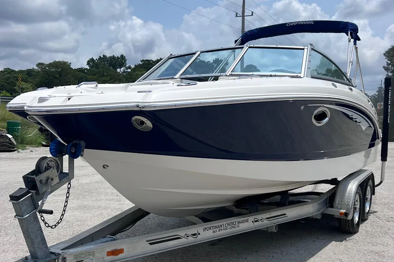 Slide: The Image of 2015 Chaparral 224 Sunesta boat, rear view with propeller, parked on concrete. - 5