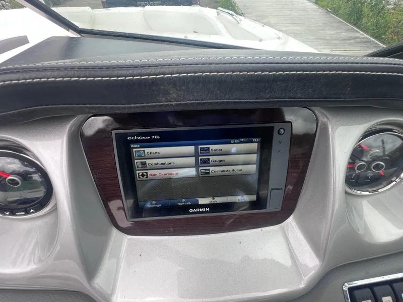 Slide: The Image of 2015 Chaparral 224 Sunesta boat interior with built-in cooler and seating. - 8