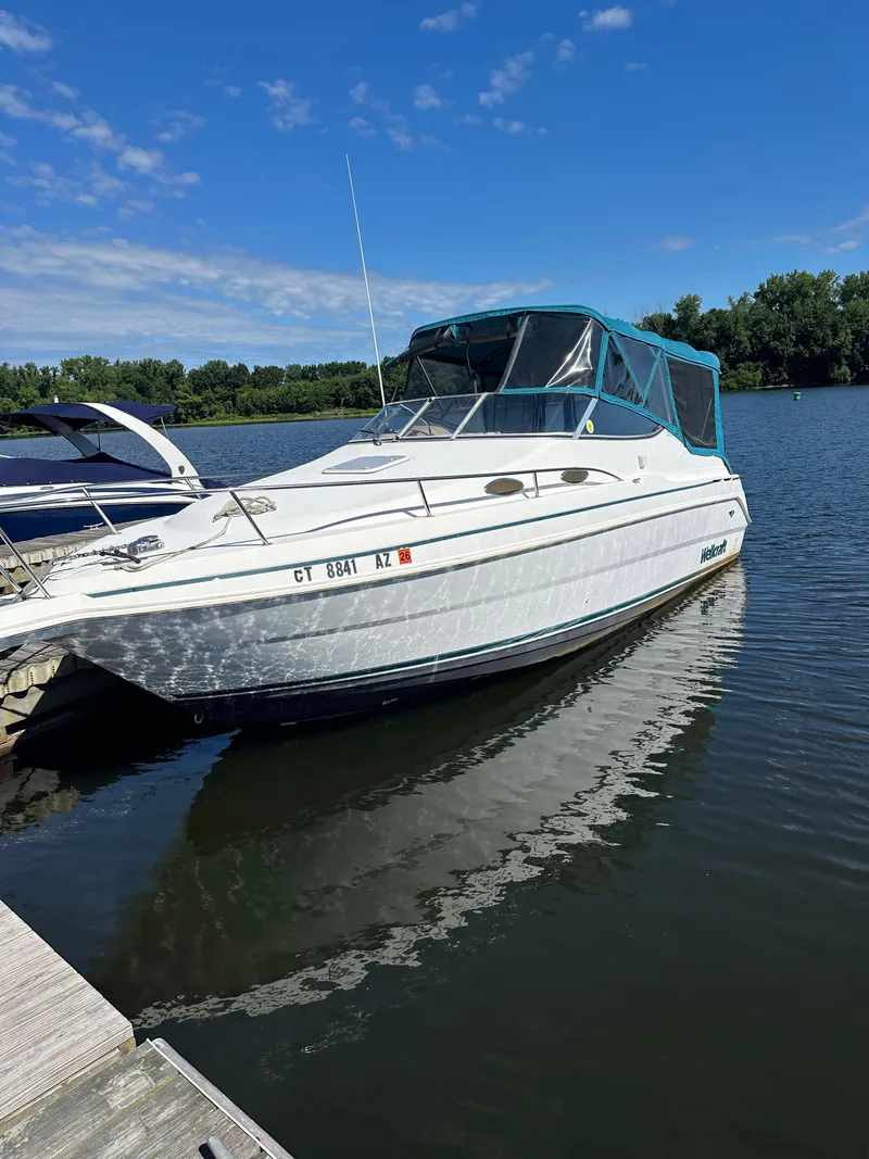 The Image of 1998 Wellcraft 260 boat docked on a sunny day with clear blue skies. - 0