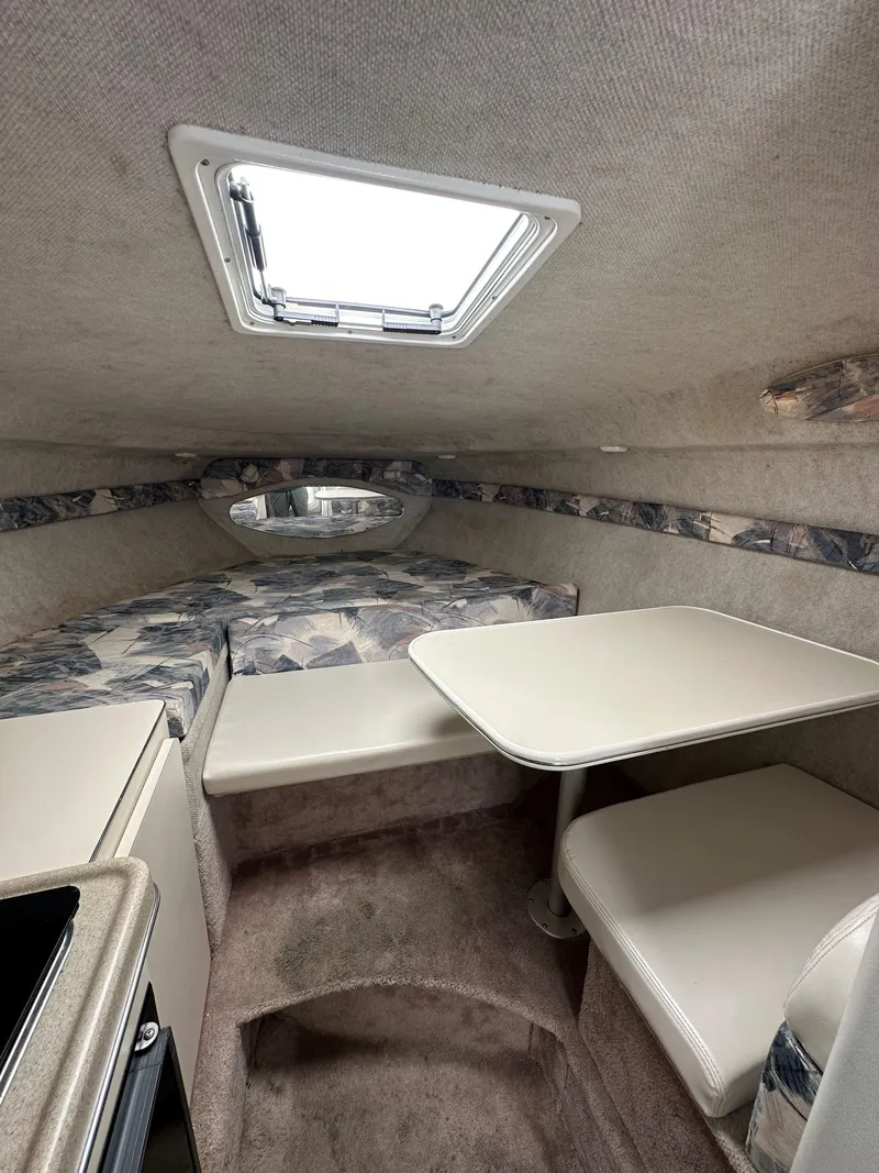 Slide: The Image of Interior of a 1998 Wellcraft 260 boat with seating and a table. - 6
