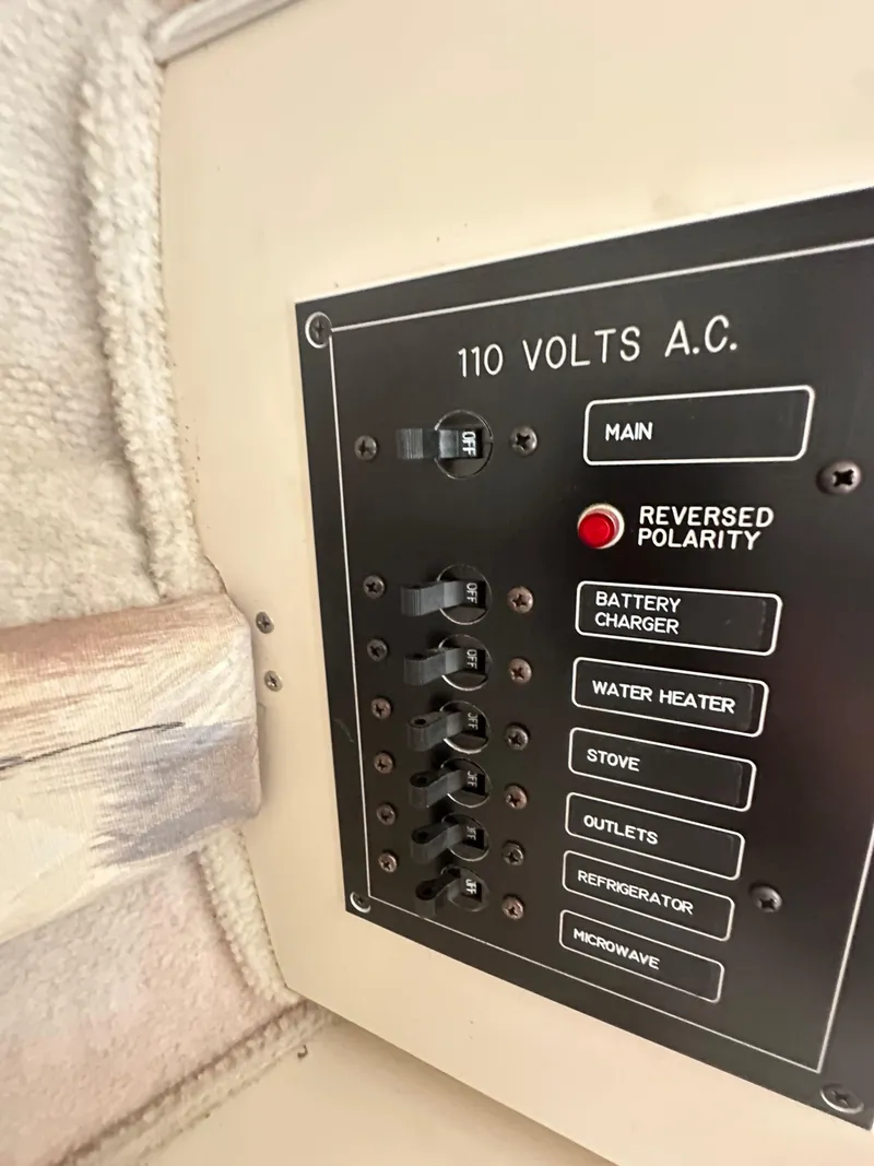 Slide: The Image of Electrical panel on a 1998 Wellcraft 260 boat, showing 110 volts A.C. switches. - 9