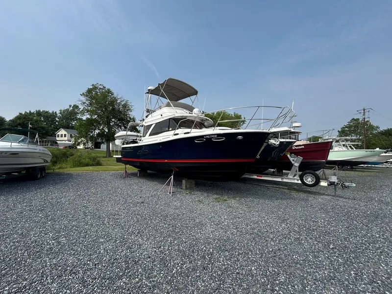 Slide: The Image of 2022 Cutwater C-32 CB boat on trailer in outdoor storage area. - 0
