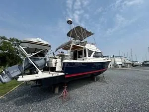 Slide: The Image of 2022 Cutwater C-32 CB boat on land, with clear sky background. - 1