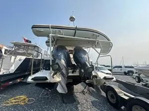 Slide: The Image of 2022 Cutwater C-32 CB boat with dual outboard motors on a trailer. - 2